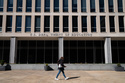 A person walks by the Department of Education building, seen with missing letters after removal of America 250 banners, Wednesday, March 18, 2026, in Washington. (AP Photo/Allison Robbert)