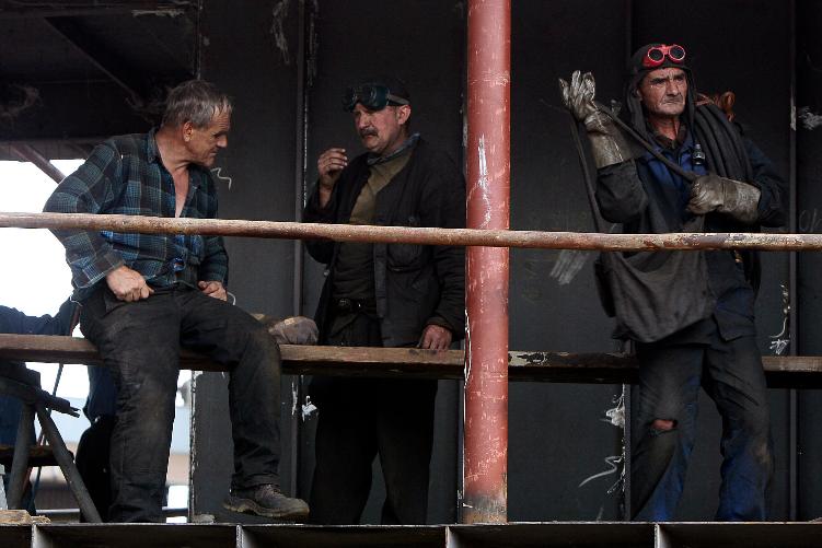 FILE - Workers stand together at a shipyard in Gdansk, Poland, Aug. 23, 2007. (AP Photo/Czarek Sokolowski, File)