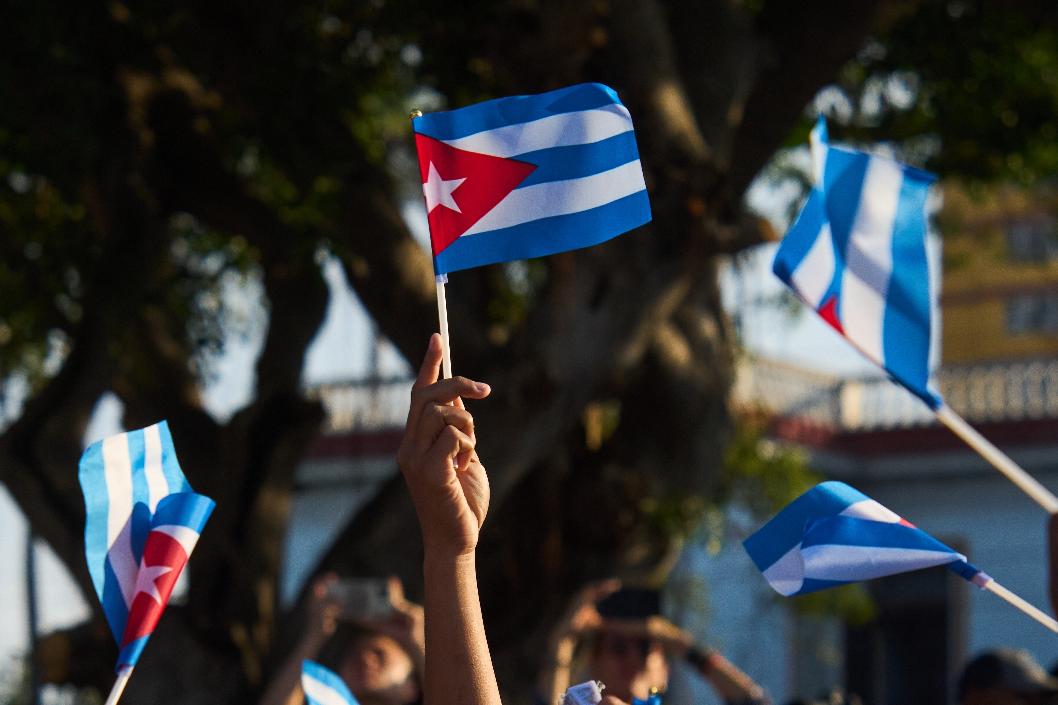 Women wave Cuban flags during a rally calling for the end of the U.S. blockade against the island nation in Havana, Cuba, Tuesday, April 7, 2026. (AP Photo/Ramon Espinosa)