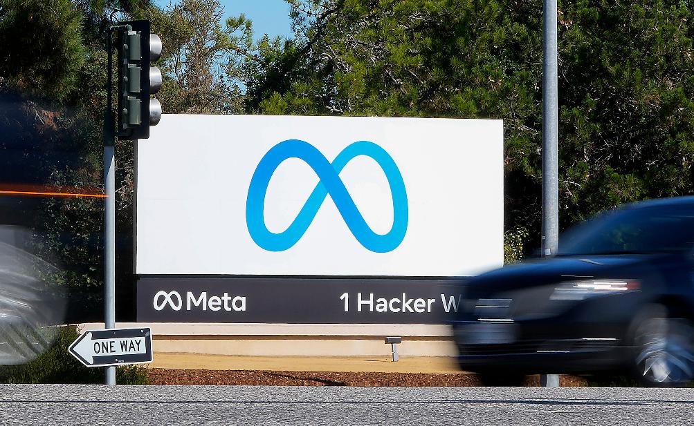 FILE - A car passes Facebook's new Meta logo on a sign at the company headquarters on Oct. 28, 2021, in Menlo Park, Calif. (AP Photo/Tony Avelar, File)