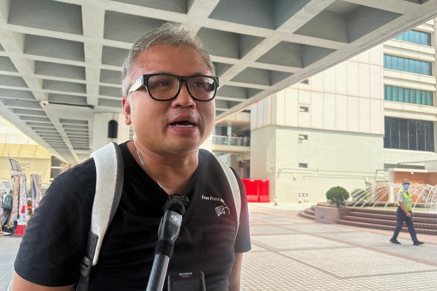 Ronson Chan, ex-chairman of the Hong Kong Journalists Association, speaks to reporters outside the High Court in Admiralty in Hong Kong before a ruling on his appeal against his conviction for obstructing a police officer, Friday, May 29, 2026. (AP Photo/Kanis Leung)