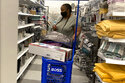 In this July 21, 2021 photo, a consumer shops as she wears a mask at a retail store in Morton Grove, Ill. Americans kept shopping last month, despite a rise in COVID-19 cases. Retail sales rose a seasonal adjusted 0.7% in August from the month before, the U.S. Commerce Department said Thursday, Sept. 16. (AP Photo/Nam Y. Huh)