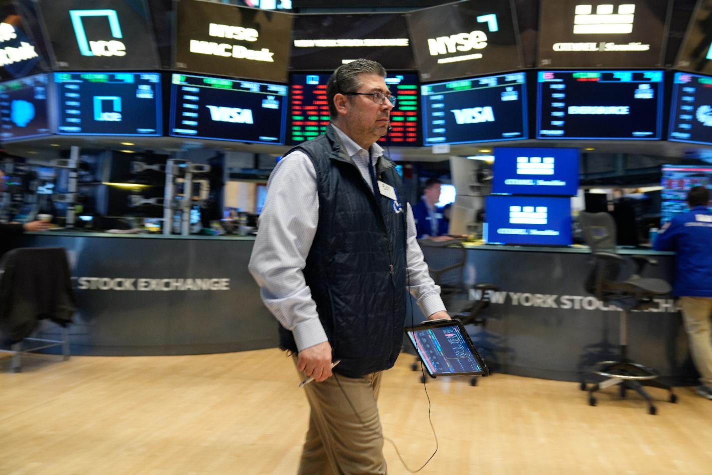 Michael Capolino works on the floor at the New York Stock Exchange in New York, Thursday, March 19, 2026. (AP Photo/Seth Wenig)