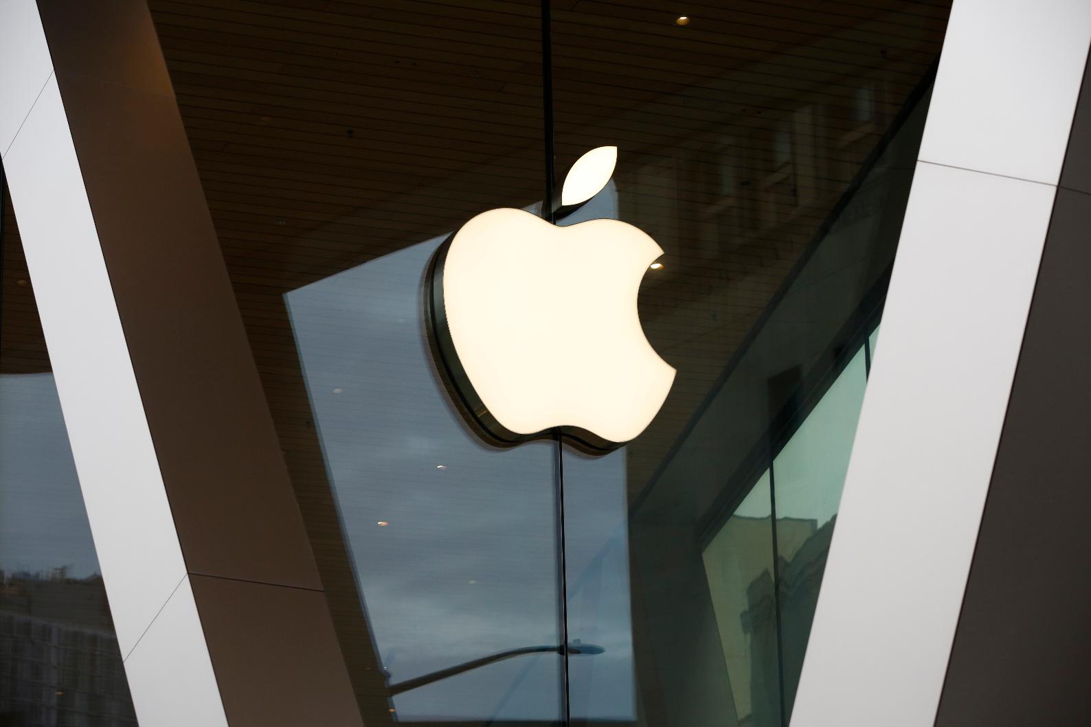 FILE - An Apple logo adorns the facade of the downtown Brooklyn Apple store on March 14, 2020, in New York. Apple became the first publicly traded company to close a trading day with a $3 trillion market value, marking another milestone for a technology juggernaut that has reshaped society with a line-up of products that churn out eye-popping profits. (AP Photo/Kathy Willens, File)