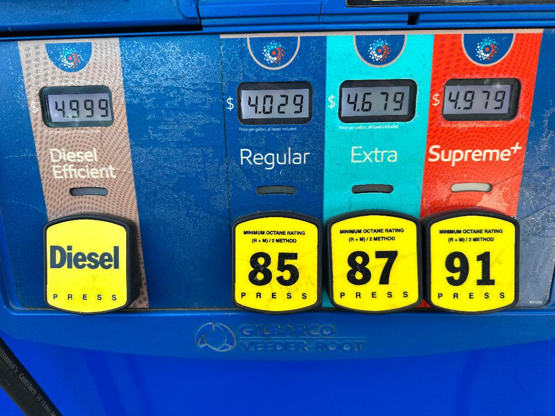 The per-gallon price is displayed electronically above the grades of gasoline available from a pump at an Exxon gasoline station in Litttleton, Colo., Tuesday, May 12, 2026. (AP Photo/David Zalubowski)