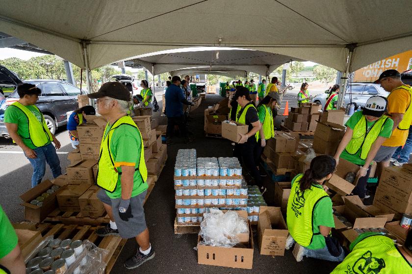 FILE - Volunteers sort produce under a tent during a Hawaii Foodbank pop-up food distribution at Leeward Community College, Nov. 9, 2025, in Pearl City, Honolulu County, Hawaii. (AP Photo/Mengshin Lin, File)