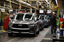 A worker walks past a line of Infiniti SUVs on a production line at the Nissan Smyrna Vehicle Assembly Plant, Thursday, April 16, 2026, in Smyrna, Tenn. (AP Photo/Kristin M. Hall)