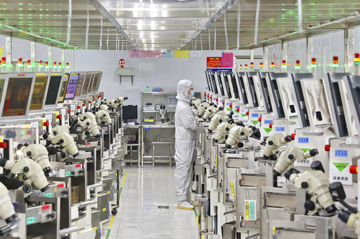 A man works at a manufacturer of Integrated Chip encapsulation in Nantong in eastern China's Jiangsu province on Friday, Sept. 16, 2022. Growth in Chinese factory activity was weak in September, export orders fell and employers cut jobs, two surveys showed Friday, Sept. 30, adding to pressure on lackluster economic growth (Chinatopix Via AP)