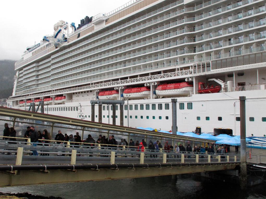 FILE - Passengers stream off the Norwegian Bliss after the vessel arrived, in Juneau, Alaska, April 25, 2022. (AP Photo/Becky Bohrer, File)