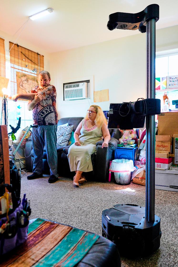 A Hello Robot gives audio and visual guidance for Brian Marquis' daily exercise routine as he recovers from a brain injury, Tuesday, April 21, 2026, in Durham, N.H. (AP Photo/Robert F. Bukaty)