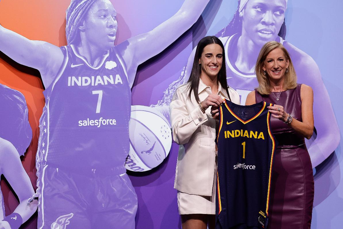 FILE - Iowa's Caitlin Clark, left, poses for a photo with WNBA commissioner Cathy Engelbert, right, after being selected first overall by the Indiana Fever during the first round of the WNBA basketball draft, April 15, 2024, in New York. The wait for full-time charter flights for WNBA teams finally is over with commissioner Engelbert announcing Tuesday, May 7, the league's plans to start the program this season. (AP Photo/Adam Hunger, File)