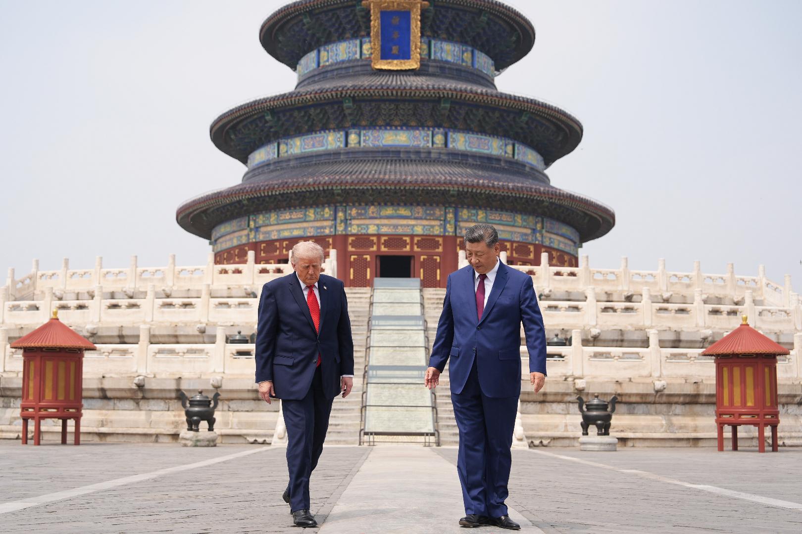 President Donald Trump, left, walks with Chinese President Xi Jinping at the Temple of Heaven on Thursday May 14, 2026, in Beijing. (AP Photo/Mark Schiefelbein)