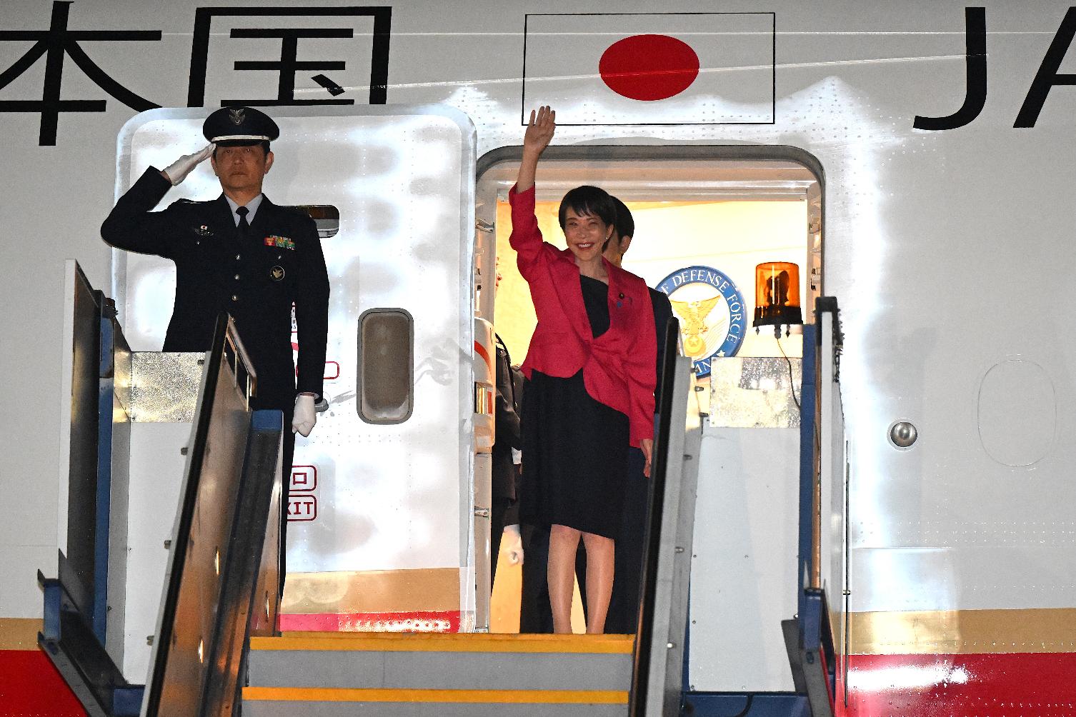 Prime Minister of Japan Sanae Takaichi, right, waves as she arrives in Canberra, Australia, Sunday, May 3, 2026. (Lukas Coch/AAP Image via AP)