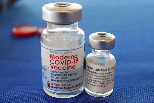 FILE - This Sept. 21, 2021 file photo shows vials of the Pfizer and Moderna COVID-19 vaccines in Jackson, Miss. Moderna is suing its main competitors Pfizer and the German drugmaker BioNTech, accusing the rivals of copying Moderna’s technology in order to make their own vaccine. Moderna said Friday, Aug. 26, 2022, that Pfizer and BioNTech’s vaccine Comirnaty infringes on patents Moderna filed several years ago protecting the technology behind its preventive shot, Spikevax. (AP Photo/Rogelio V. Solis, File)