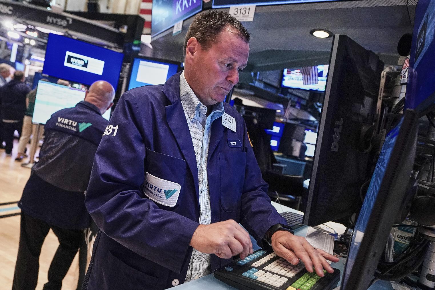 Trader Matthew Cheslock, right, works on the floor of the New York Stock Exchange, Tuesday, June 16, 2026. (AP Photo/Richard Drew)