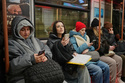 Passengers look at their smartphones while on the subway in Moscow, Wednesday, Feb. 11, 2026. (AP Photo/Alexander Zemlianichenko)