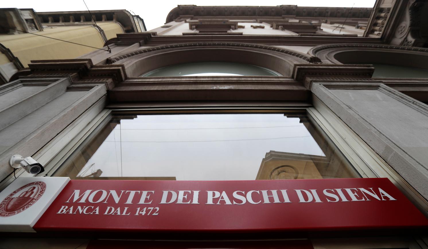 FILE - A view of a ' Monte Dei Paschi di Siena ' bank branch in Milan, Italy, Monday, Dec. 19, 2016. (AP Photo/Antonio Calanni, File)