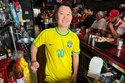 Lion Sports Bar owner Mark Prinzinger poses behind the bar as fans watch a Champion league soccer match between Arsenal and Paris Saint-Germain, Saturday, May 30, 2026, in Philadelphia. (AP Photo/Tassanee Vejpongsa)