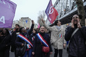 French Lawmakers Danielle Obbono, left and Mathilde Panot march during a protest in Paris, Wednesday, March 22, 2023. Macron said Wednesday that the pension bill that he pushed through without a vote in parliament needs to be implemented by the "end of the year." Meanwhile, oil shipments in the country were disrupted amid strikes at several refineries in western and southern France. (AP Photo/Lewis Joly)