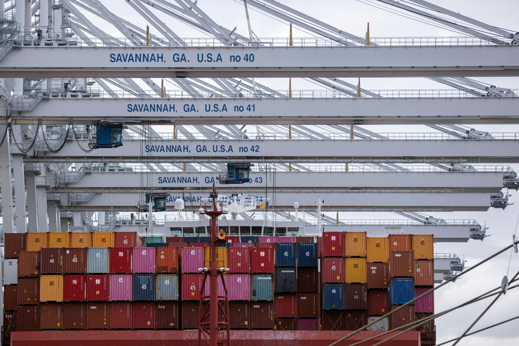FILE- In this photo provided by the Georgia Ports Authority, a vessel is loaded with containers by several ship to shore crane at the Georgia Ports Authority's Port of Savannah Garden City Terminal, on Oct. 21, 2021, in Savannah, Ga. (AP Photo/Georgia Port Authority, Stephen B. Morton, file)