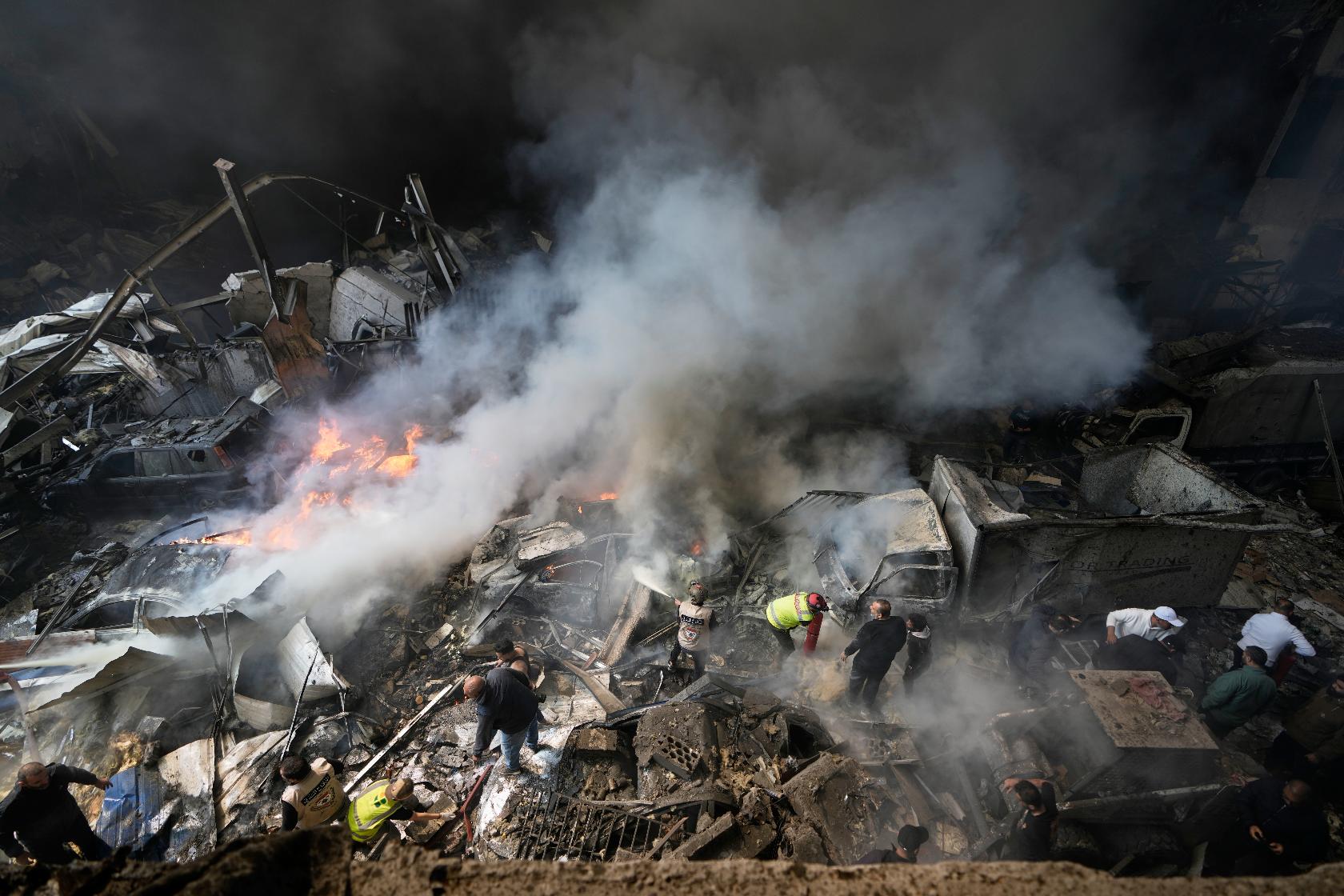 First responders search at the site of an Israeli airstrike that struck an apartment building in Beirut, Lebanon, Wednesday, April 8, 2026. (AP Photo/Bilal Hussein)