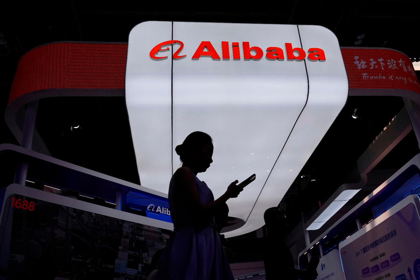 FILE - A visitor walks in front of Alibaba booth during the 3rd China International Supply Chain Expo at the China International Exhibition Center, in Beijing, China, Friday, July 18, 2025. (AP Photo/Mahesh Kumar A., file)