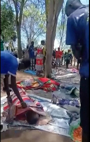 In this image made from video, dead bodies are seen covered on the ground, after gunmen killed more than 70 people in South Sudan over a gold mining row on the outskirts of the capital, in Jebel Iraq, South Sudan, Sunday, March 29, 2026. (Aweil News Agency via AP)