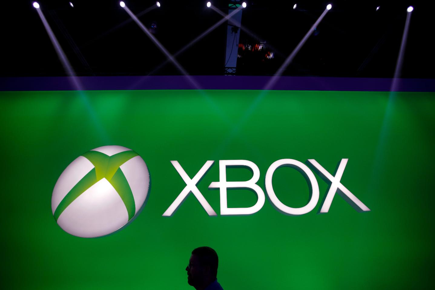 FILE - A man walks past the Xbox logo at the Microsoft booth during the E3 game show in Los Angeles, Tuesday, June 11, 2013. (AP Photo/Jae C. Hong, File)