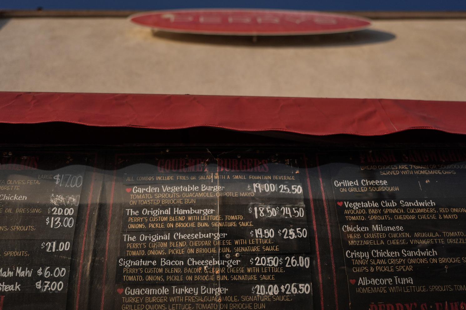 Menu prices are displayed at a cafe in Santa Monica, Calif., Wednesday, May 20, 2026. (AP Photo/Jae C. Hong)