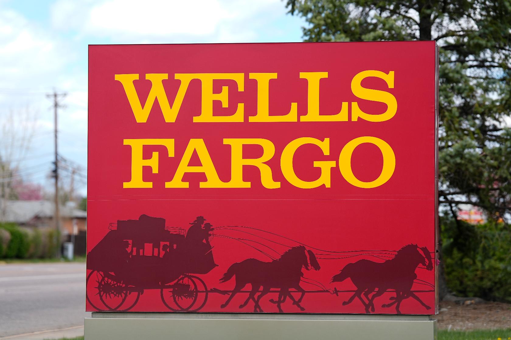 FILE - A sign stands outside a branch of Wells Fargo bank on April 17, 2024, in Littleton, Colo. Wells Fargo reports earnings on Friday, July 12, 2024. (AP Photo/David Zalubowski, File)
