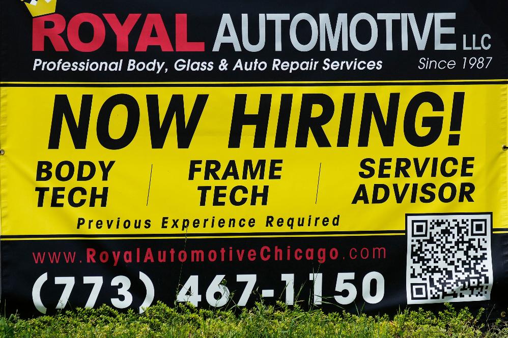 FILE - A now hiring sign is seen in front of an auto body shop in Chicago, June 25, 2026. (AP Photo/Nam Y. Huh, file)