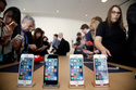 FILE- In this March 21, 2016, file photo members of the media and invited guests take a look at the new iPhone SE during an event at Apple headquarters in Cupertino, Calif. (AP Photo/Marcio Jose Sanchez, file)
