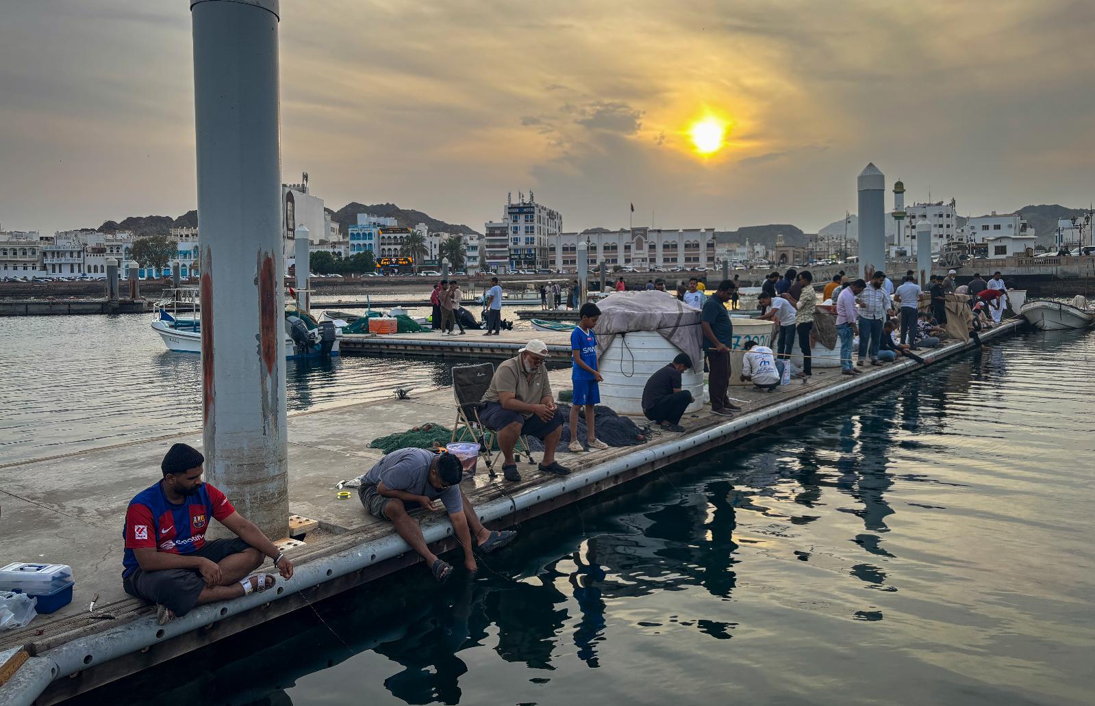 FILE - People fish along a pier near Mutrah Corniche in Muscat, Oman, on Feb. 6, 2026. (AP Photo/Altaf Qadri, File)