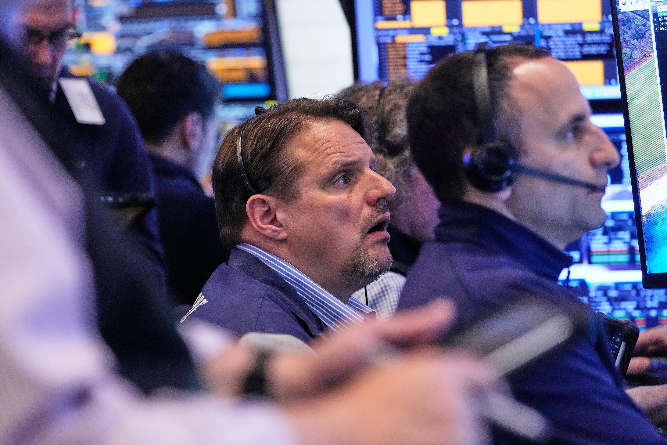 Trader Michael Milano, center, works with colleagues on the floor of the New York Stock Exchange, Wednesday, May 13, 2026. (AP Photo/Richard Drew)
