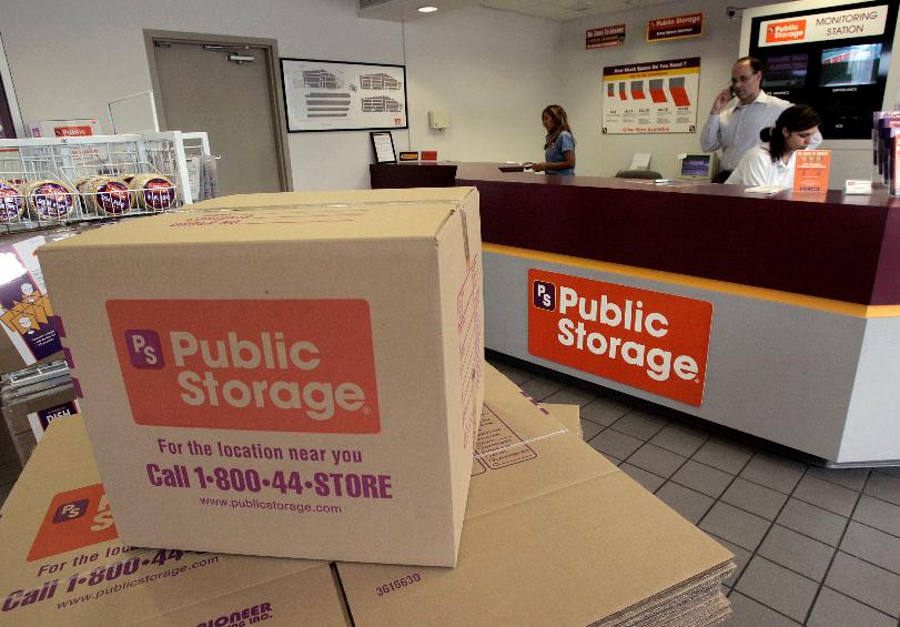 FILE - Carol Avalos, far left, Wes Demory, center, and Desiree Mora working at the customer service desk for Public Storage, Inc. on March 7, 2006, in the Eagle Rock section of Los Angeles. (AP Photo/Ric Francis, File)