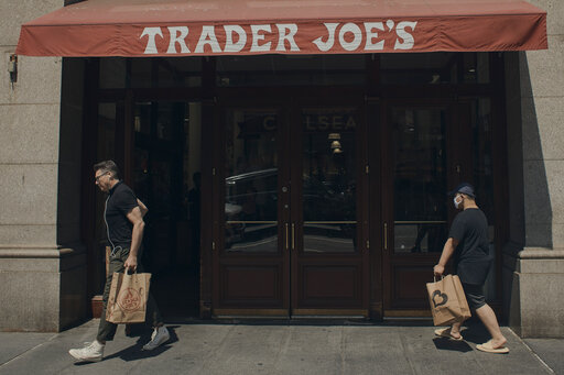 People shop at a supermarket on Wednesday, July 27, 2022 in New York.   The Federal Reserve on Wednesday raised its benchmark interest rate by a hefty three-quarters of a point for a second straight time in its most aggressive drive in three decades to tame high inflation.  The Fed is tightening credit even while the economy has begun to slow, thereby heightening the risk that its rate hikes will cause a recession later this year or next. (AP Photo/Andres Kudacki)