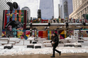 A person walks past 2 World Trade Center where American Express will build new global headquarters, Wednesday, Feb. 25, 2026, in New York. (AP Photo/Yuki Iwamura)