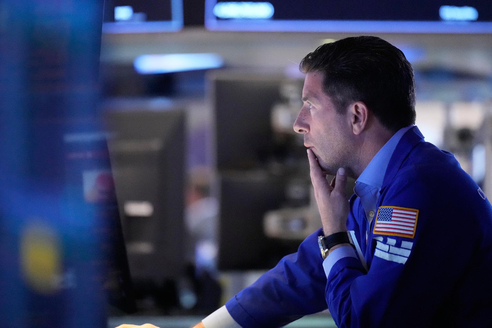 People work on the floor at the New York Stock Exchange in New York, Monday, April 13, 2026. (AP Photo/Seth Wenig)