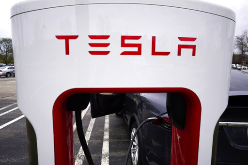 FILE - Tesla Supercharger is seen at Willow Festival shopping plaza parking lot in Northbrook, Ill., on May 5, 2022. Tesla shareholders on Thursday, Aug. 4, 2022 approved a three-for-one stock split, a move that will make the company's shares more accessible to smaller investors. (AP Photo/Nam Y. Huh, File)