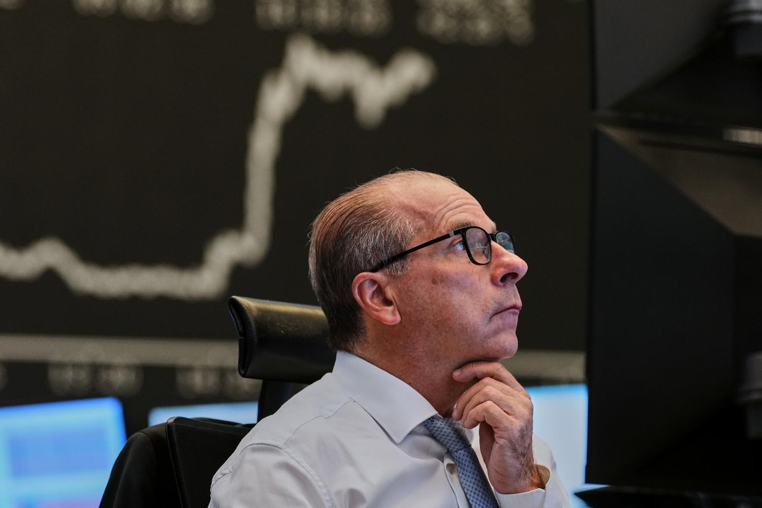 A broker watches his screens at the stock market in Frankfurt, Germany, Friday, April 17, 2026. (AP Photo/Michael Probst)