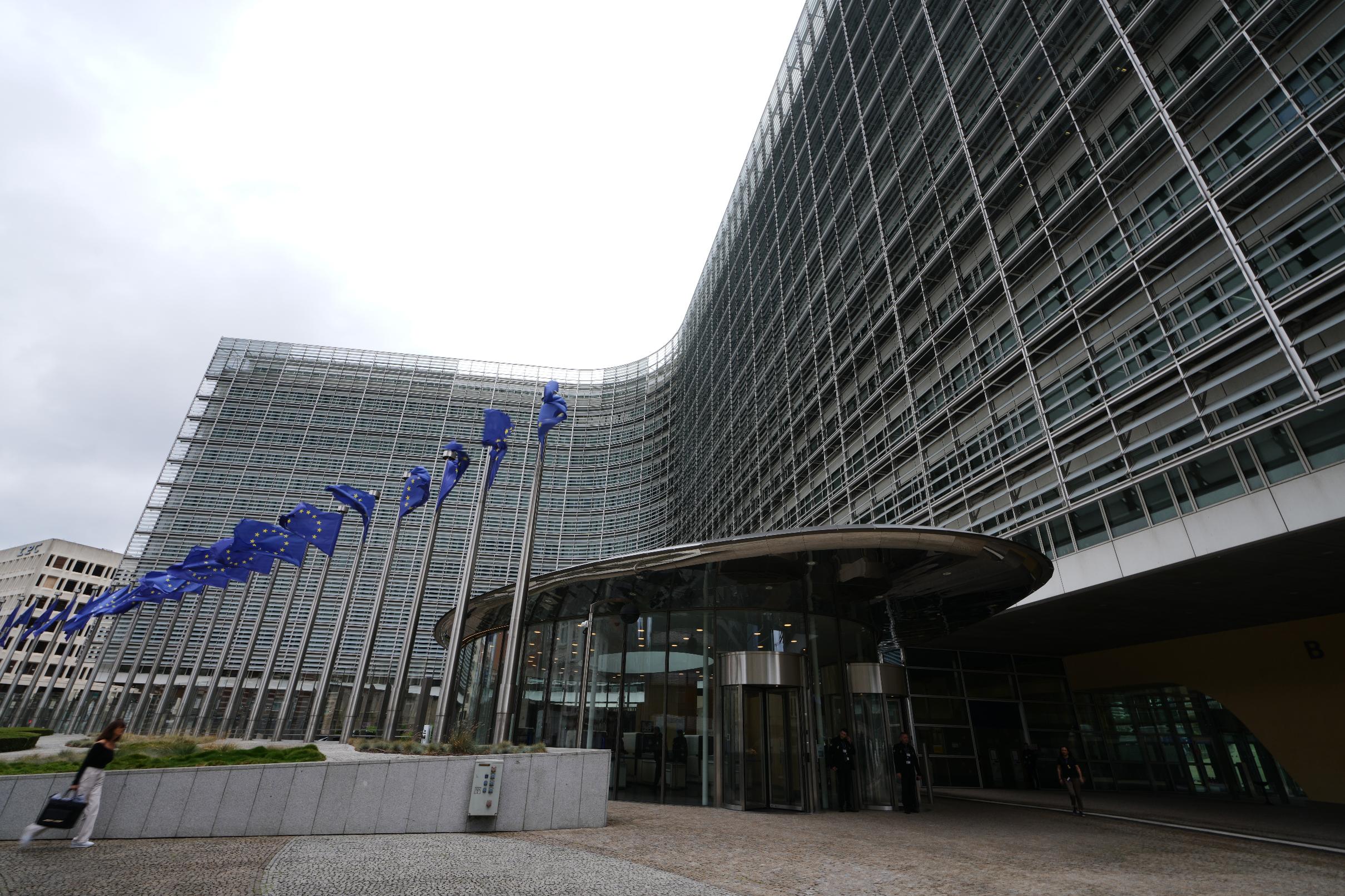 European Union flags flap in the wind outside EU headquarters in Brussels, prior to an announcement regarding Google, Thursday, July 23, 2026. (AP Photo/Virginia Mayo)