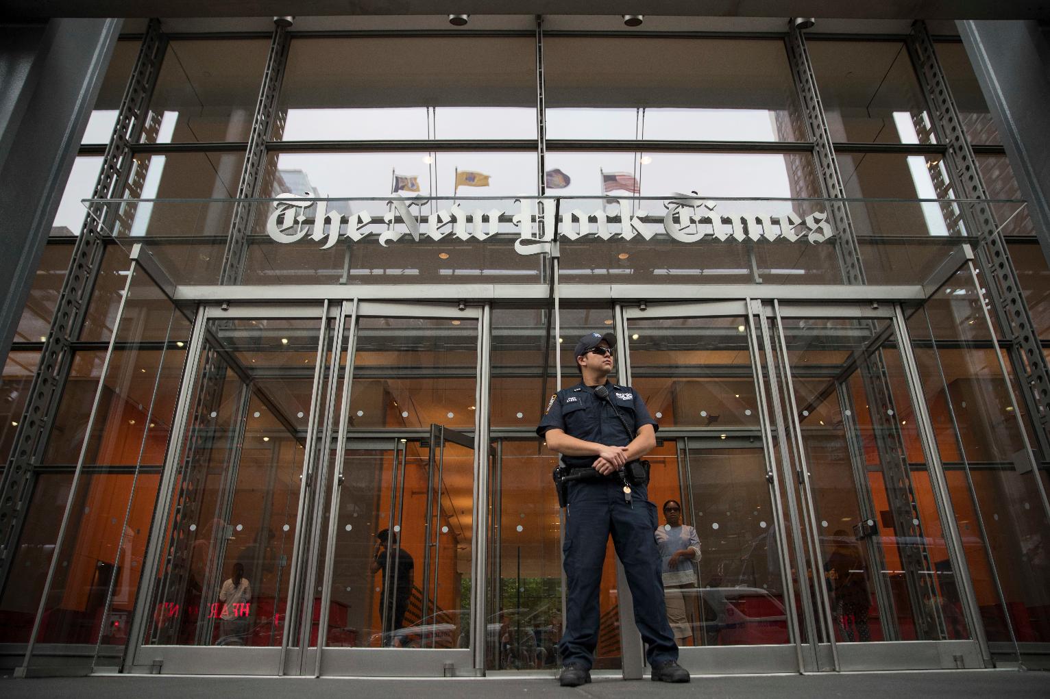 FILE- A police officer stands guard outside The New York Times building in New York, on June 28, 2018. (AP Photo/Mary Altaffer, File)