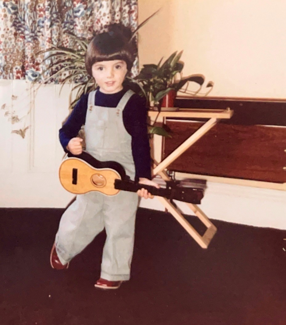 In this undated photo provided by Samuel Smith, the musician as a young child poses with a toy guitar. (Samuel Smith via AP)
