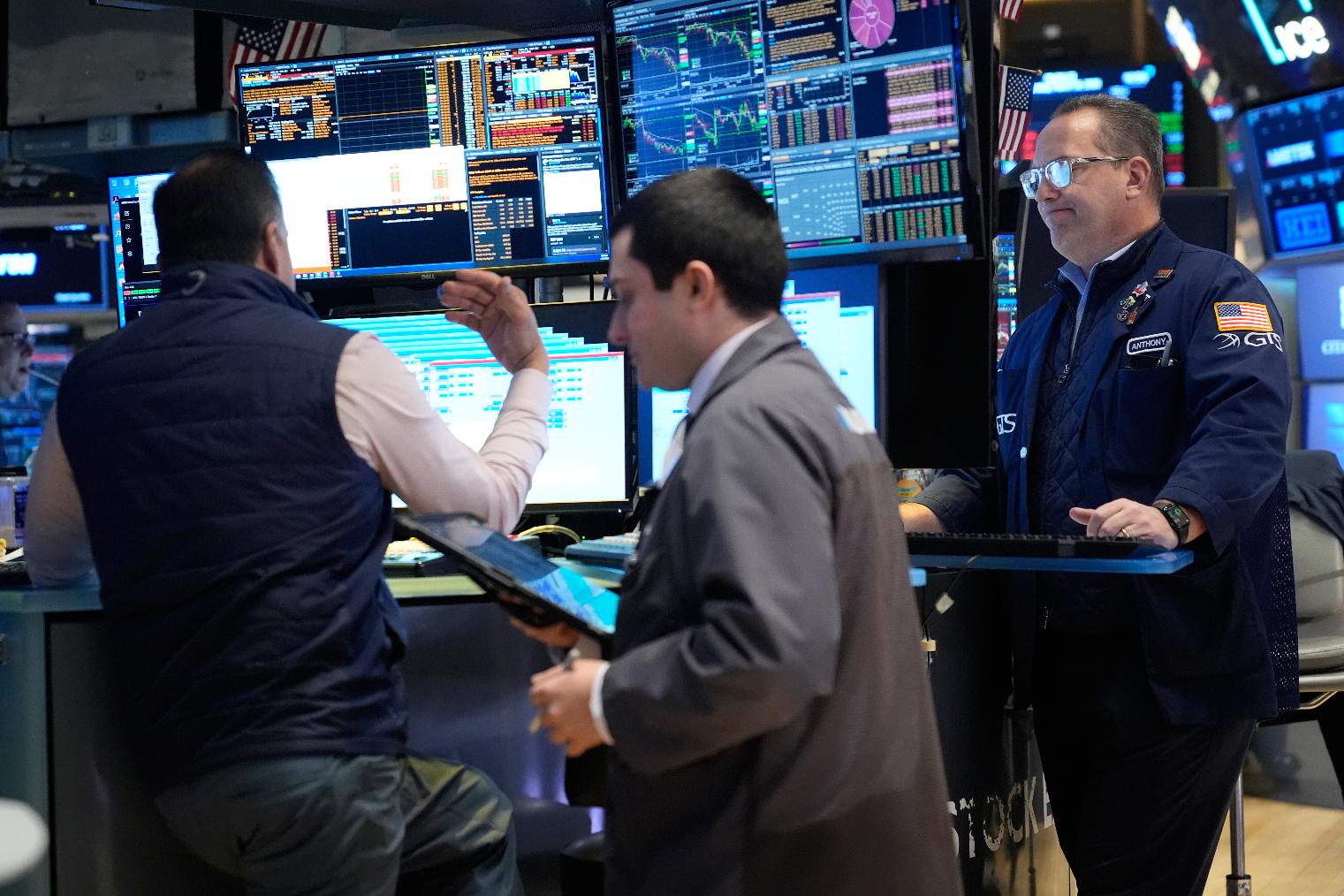 Traders work on the floor at the New York Stock Exchange in New York, Thursday, March 19, 2026. (AP Photo/Seth Wenig)