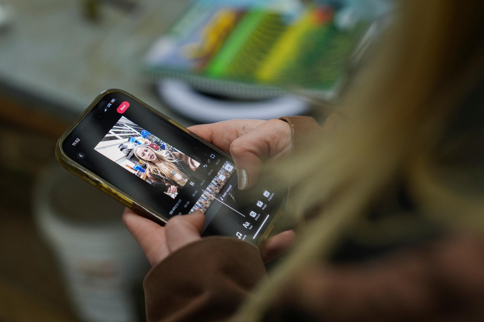 FILE - Zoe Kent edits a social media video on the TikTok app, Jan. 20, 2025, at her farm in Bucyrus, Ohio. (AP Photo/Joshua A. Bickel, File)
