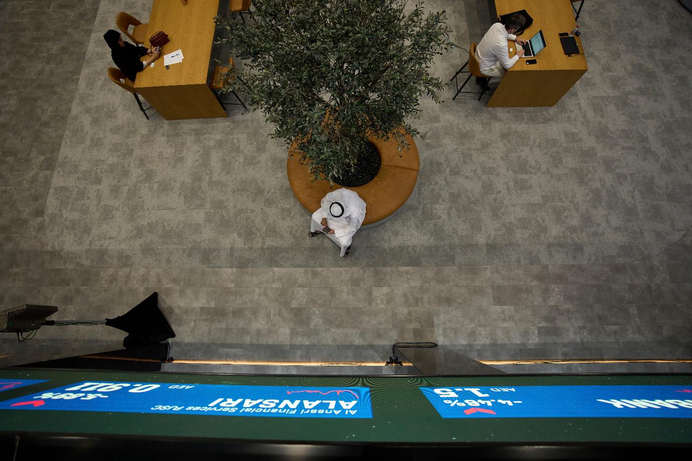Emiratis are seen in the Dubai Financial Market in Dubai, United Arab Emirates, Monday, April 7, 2025. (AP Photos/Fatima Shbair)