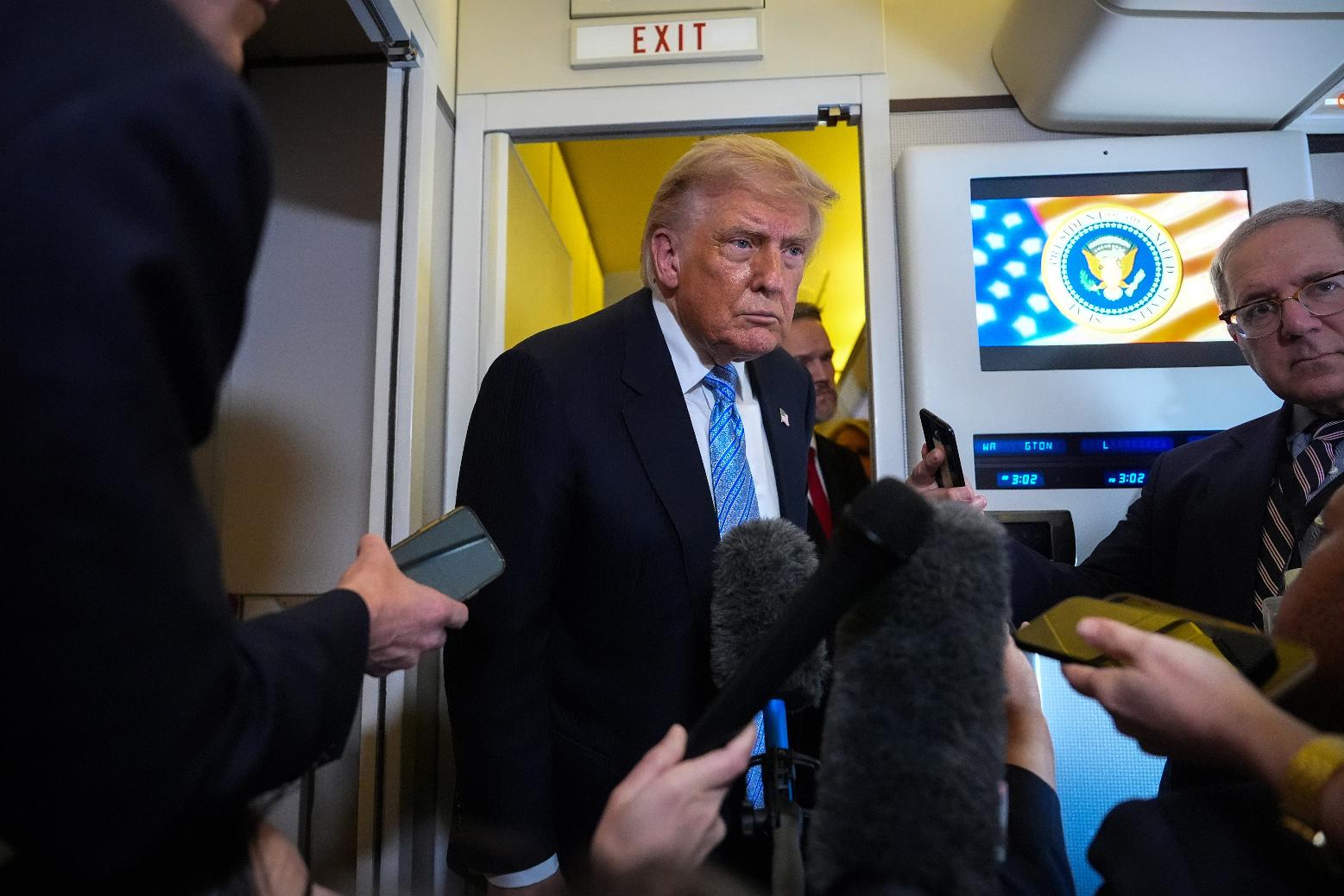 President Donald Trump speaks to reporters aboard Air Force One, Friday, May 15, 2026, as he returns from a trip to Beijing, China. (AP Photo/Mark Schiefelbein)
