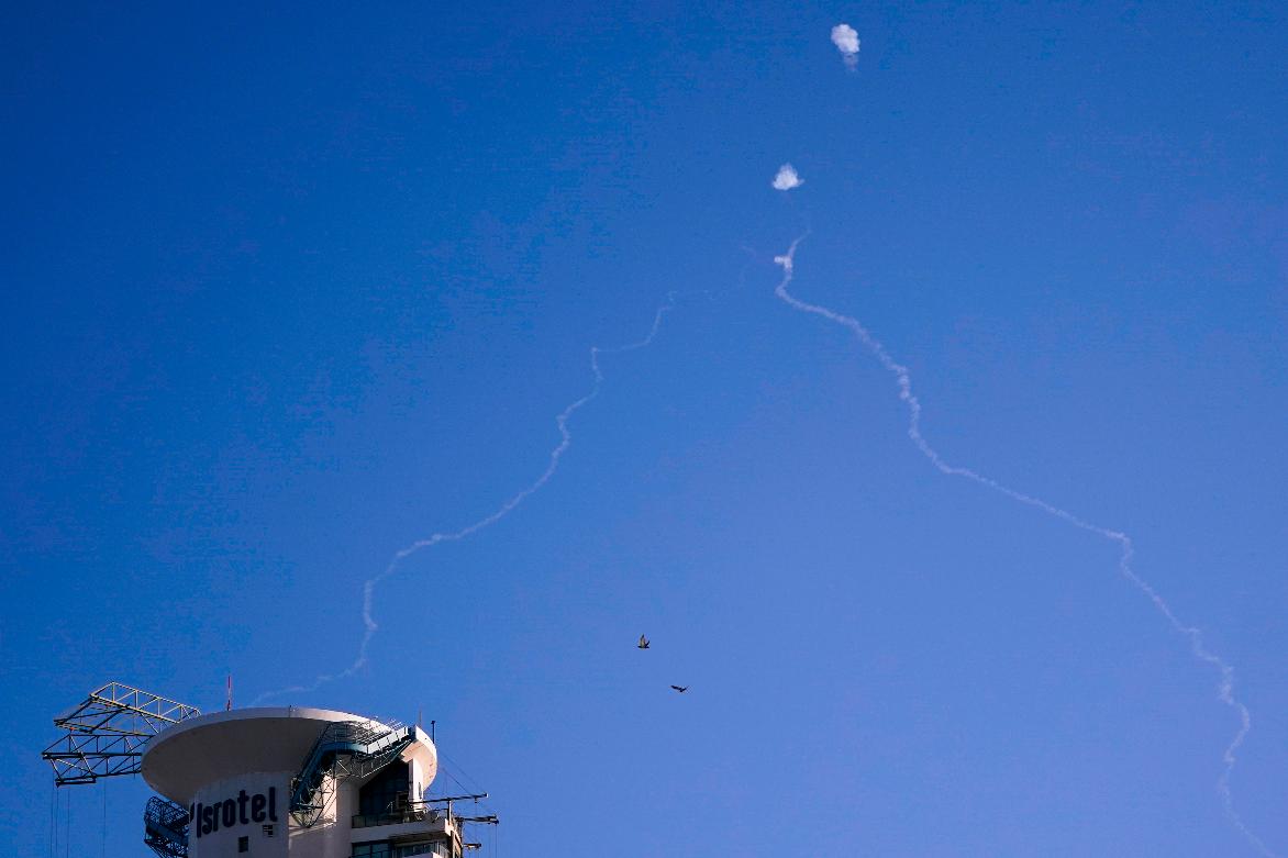 FILE - Israel's Iron Dome anti-missile system fires to intercept as air raid sirens sound in Tel Aviv, on Oct. 23, 2024. (Nathan Howard/Pool Photo via AP, File)