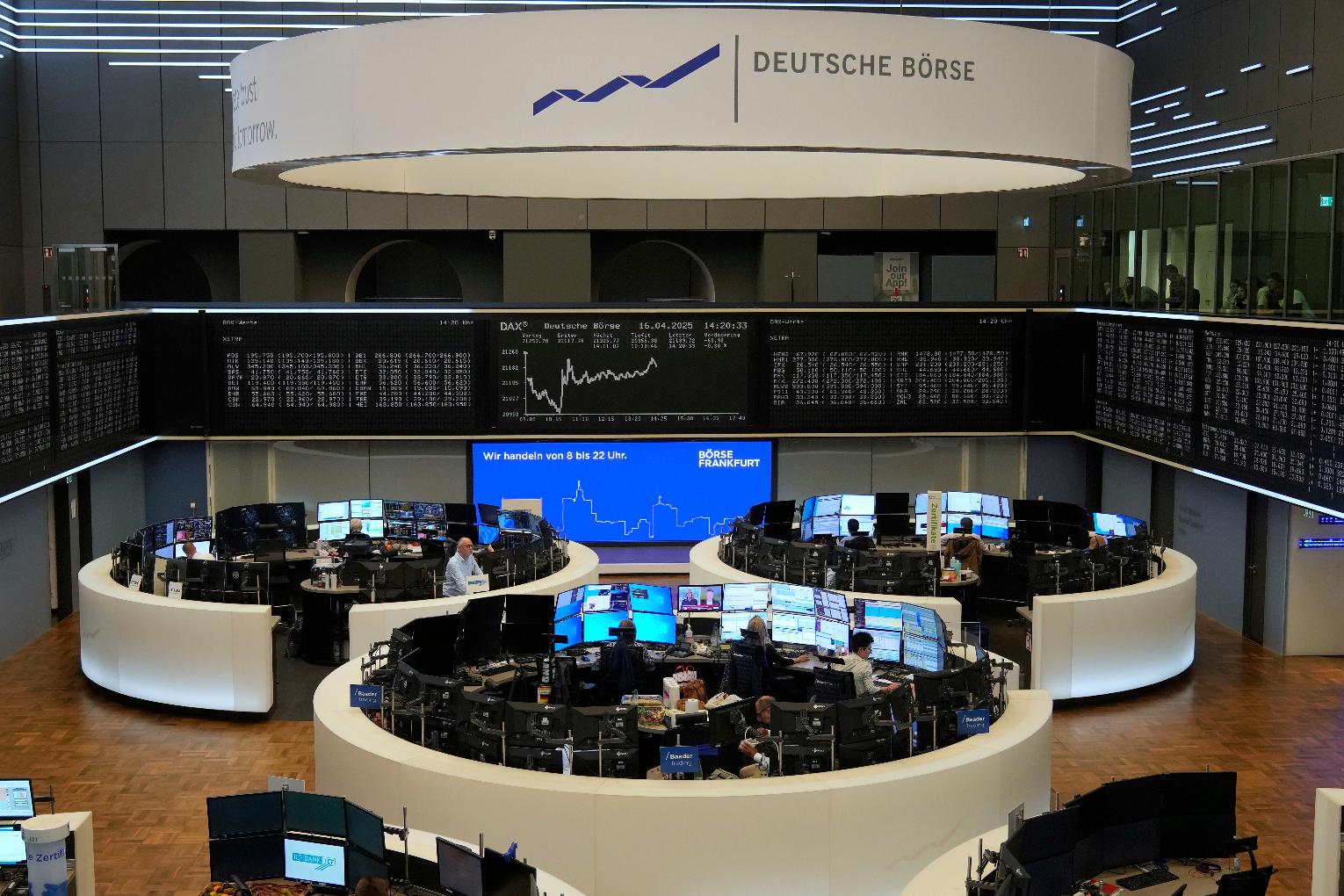 Broker watches their screens at the stock market in Frankfurt, Germany, Wednesday, April 16, 2025. (AP Photo/Matthias Schrader)