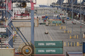 Containers are stacked at the Port of Long Beach Friday, Feb. 20, 2026, in Long Beach, Calif. (AP Photo/Damian Dovarganes)
